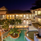 There is a poolside BBQ within a tropical garden of shaded palms and lush ferns - Regal Port Douglas